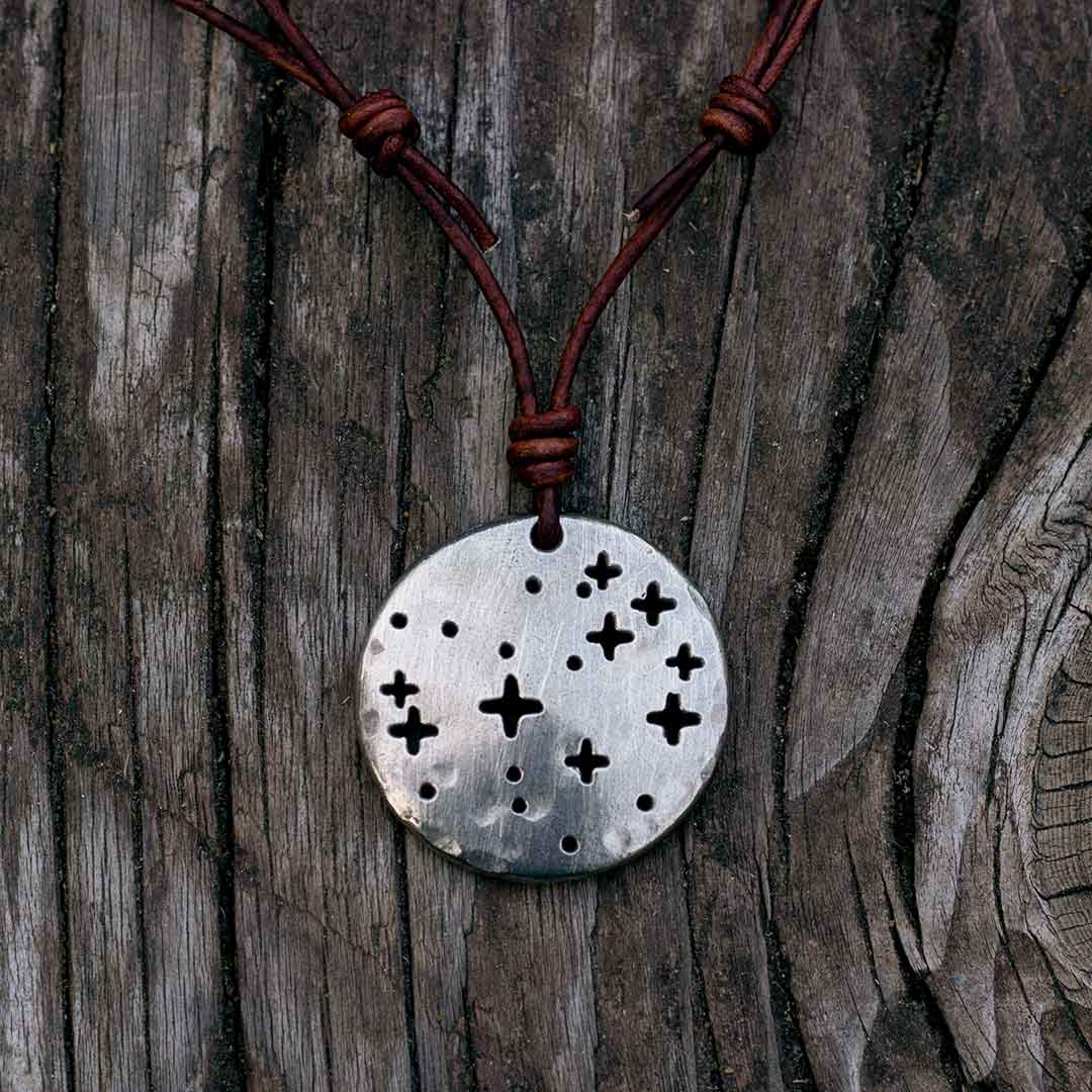 Pleiades constellation necklace - science & astronomy jewelry. Great gift for a star gazer, teacher, or astronomer. Pendant on a brown cord.