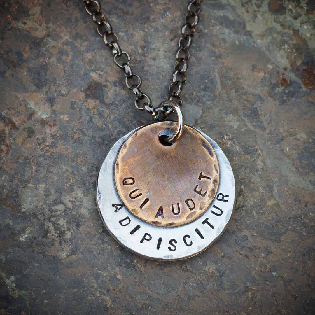 Qui Audet Adipiscitur - "She Who Dares, Wins" Necklace - Perfect science jewelry for innovators, experimenters, entrepreneurs,  and anyone with a dream. Makes a beautiful gift for graduations, birthdays, or starting a new challenging venture. Hand-stamped weathered bronze and aluminum discs, hung from a 28 inch gunmetal chain.