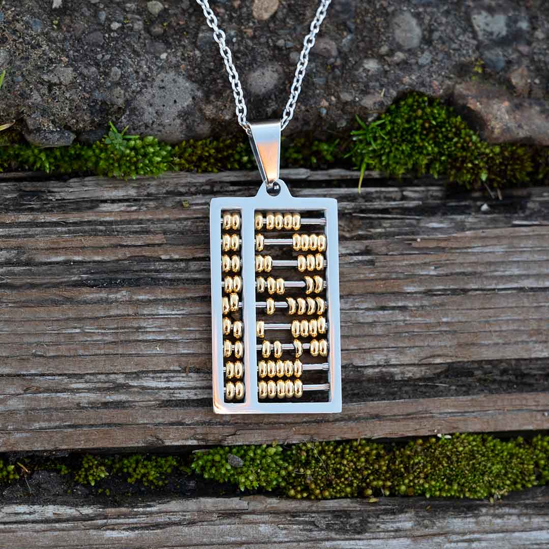 Abacus Necklace - Great science jewelry gift for a mathematician, math teacher, or student! Steel pendant measures 1 ¼ inches long and ¾ inch wide with moving gold beads on 24 inch steel link chain.