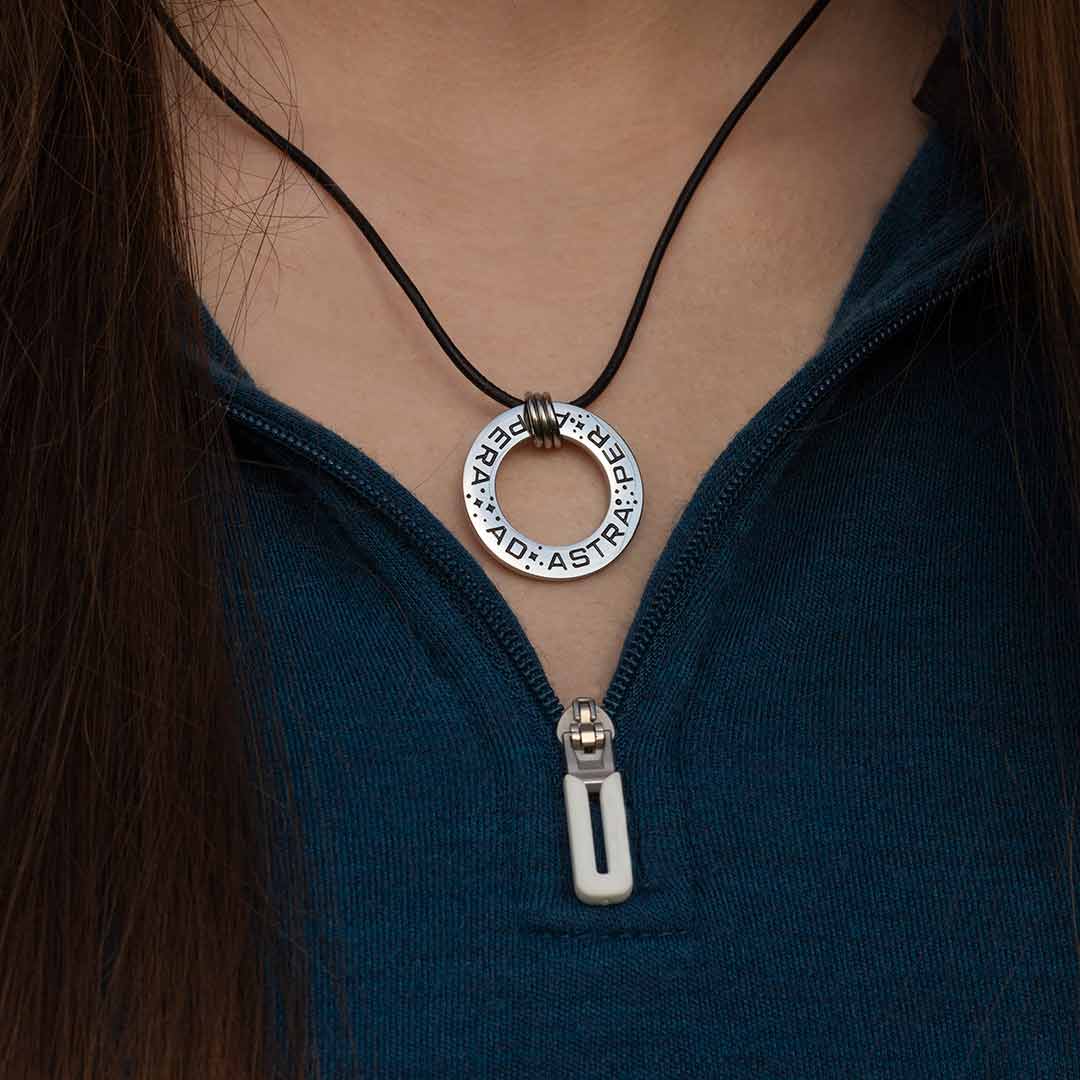 Ad Astra Per Aspera Necklace - Perfect science jewelry gift for space science enthusiasts, astronomy students &amp; instructors, and anyone with a dream to follow, despite the challenges. Steel disc pendant is engraved with the Latin phrase “AD ASTRA PER ASPERA”, which translates as “to the stars, through difficulties”. Each word is framed with tiny stars, and the pendant freely moves within three steel jump rings and is hung on an adjustable black leather cord.