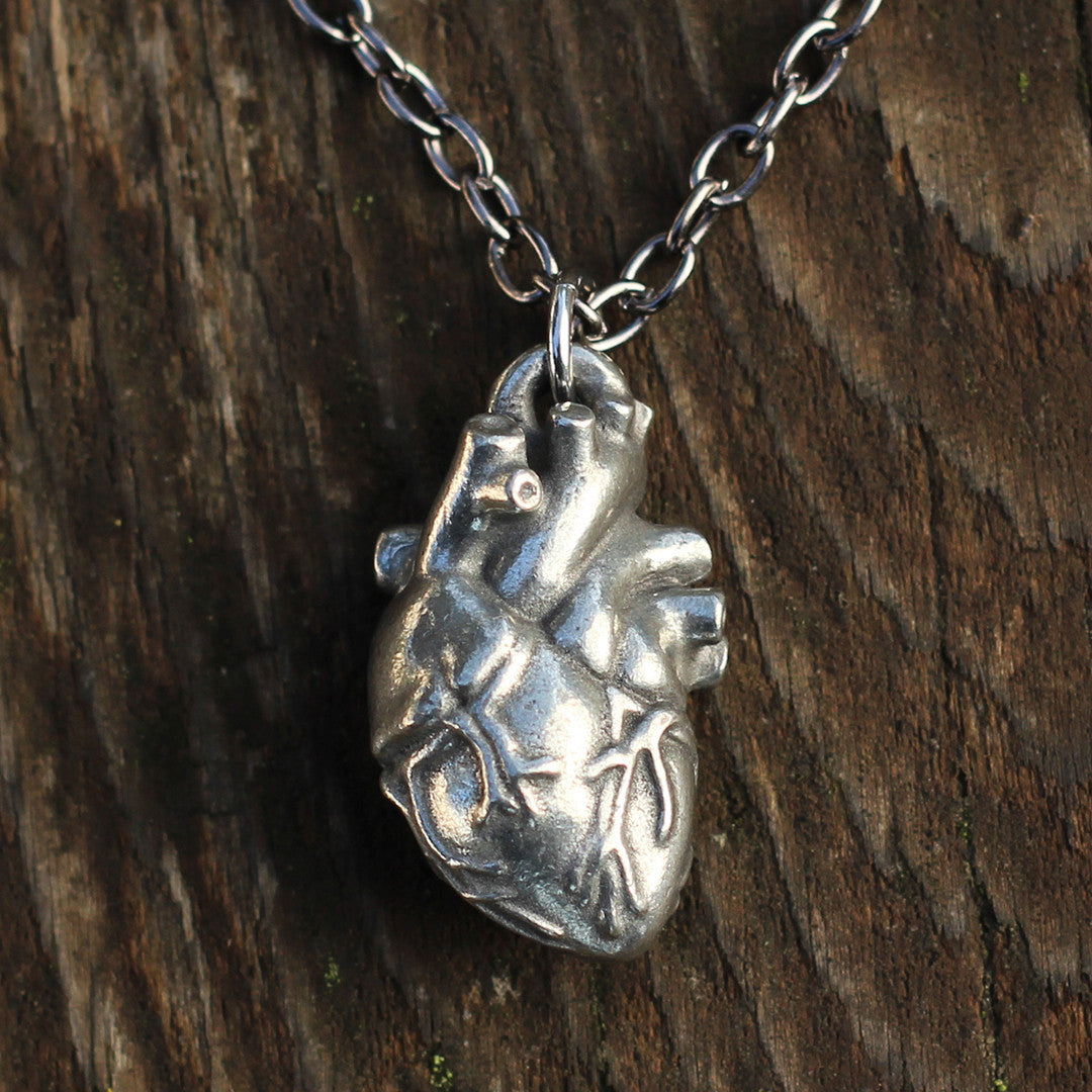 Pewter Anatomical Heart Necklace - Perfect science jewelry gift for nurses, doctors, med students, cardiologists, medical researchers, science teachers, and lovers. This pewter anatomically correct heart necklace has meticulously correct details, including the aorta, vena cava, pulmonary arteries and veins, and the finely branched coronary blood vessels. Pendant is small batch cast from genuine pewter and given an antique finish and  hung on an 18 inch or 32 inch heavyweight gunmetal chain.
