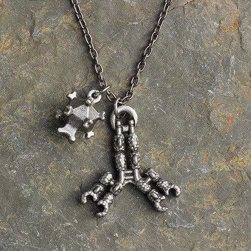 Antibody and Virus Necklace - Perfect science jewelry gift for biologists, researchers, immunologists, doctors, nurses, med students, and science lovers. Beautifully detailed antibody and virus pendants actually fit together in the antigen binding site and are pewter cast from hand-carved models with details of amino acid chains, regions, and disulfide bonds. The larger piece is about 1.5 inches at its widest point. Pendants are strung together on an 18 or 32 inch gunmetal chain.