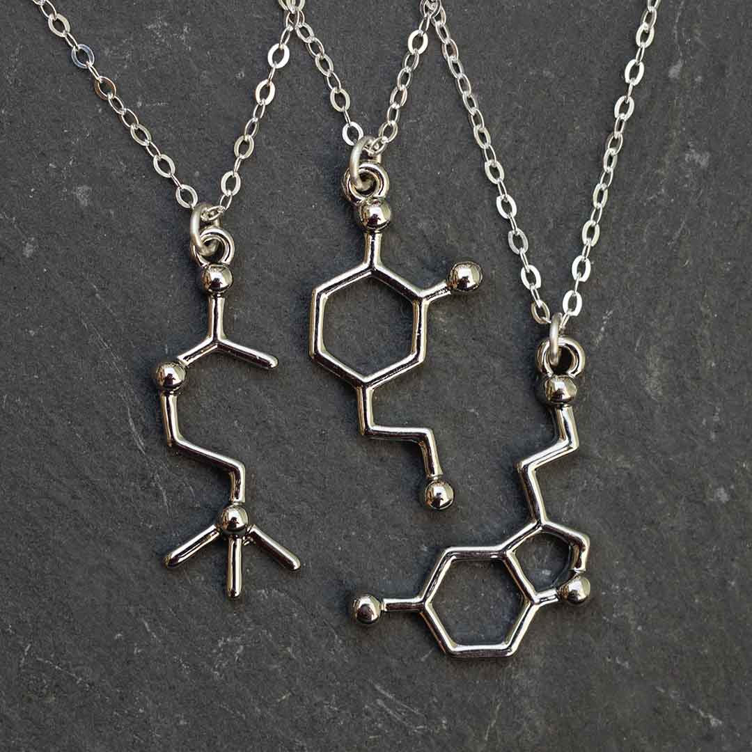 Neurotransmitter molecule necklace - acetylcholine, dopamine, and serotonin. Biology science jewelry that makes a great gift for a scientist, student, or teacher.