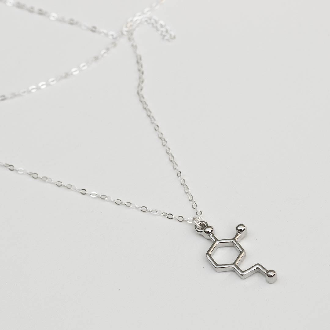 Neurotransmitter molecule dopamine necklace. Biology science jewelry that makes a great gift for a scientist, student, or teacher.