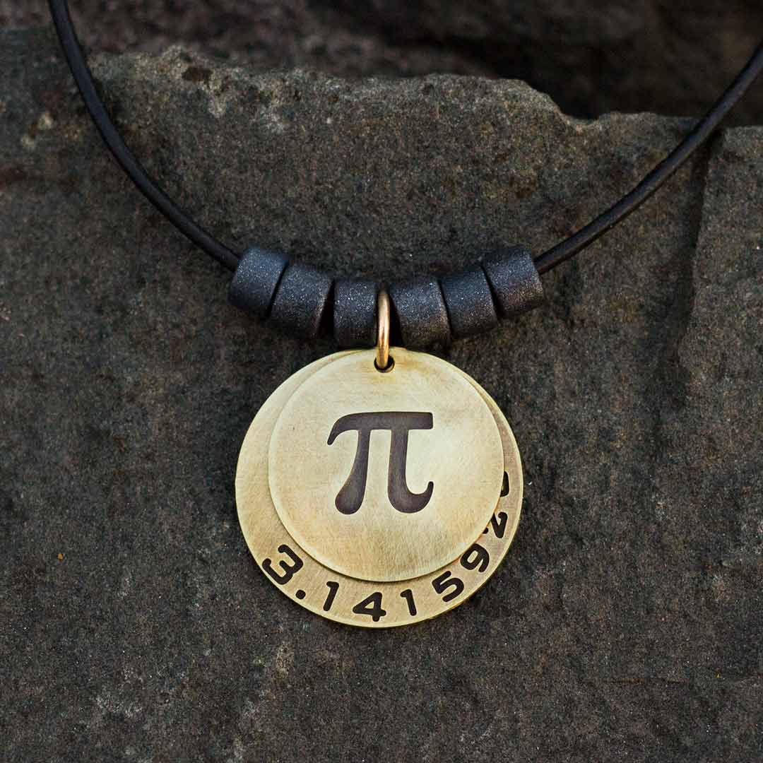 Pi math necklace showing the pi symbol on one disc and pi to 35 decimal places on the second disc. Great gift for a mathematician, a student or a teacher of mathematics. 