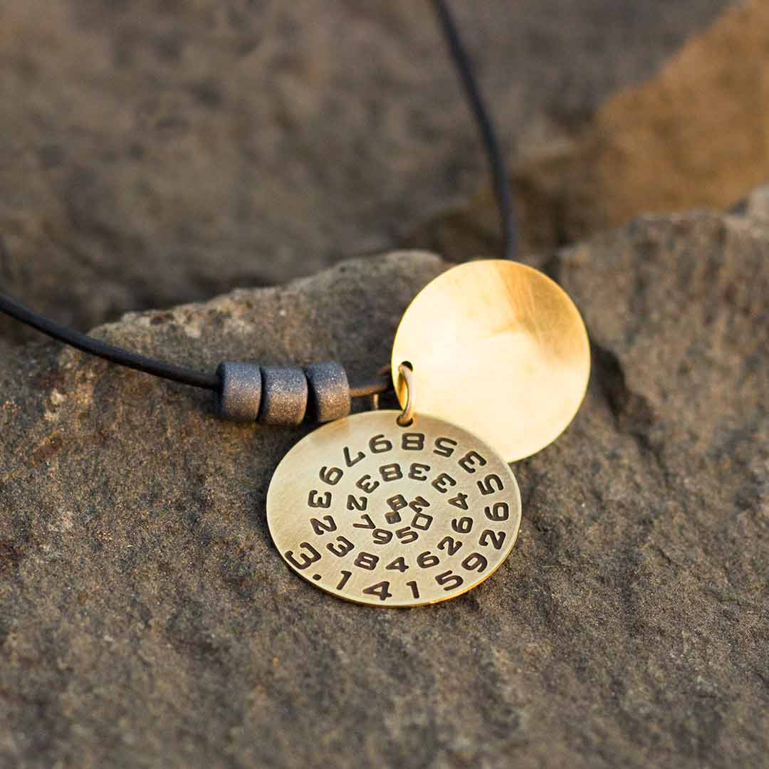 Pi math necklace showing the pi symbol on one disc and pi to 35 decimal places on the second disc. Great gift for a mathematician, a student or a teacher of mathematics. 