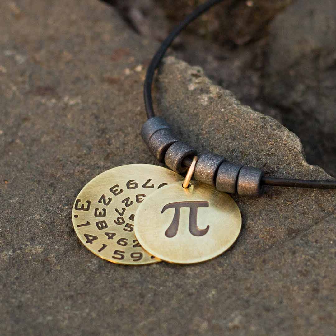 Pi math necklace showing the pi symbol on one disc and pi to 35 decimal places on the second disc. Great gift for a mathematician, a student or a teacher of mathematics. 