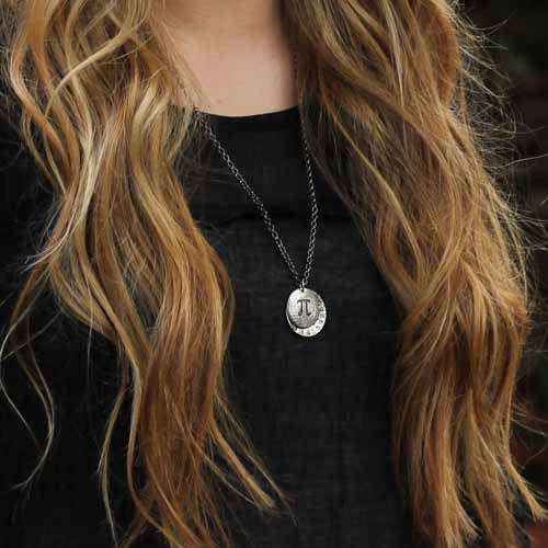 Pi math necklace showing the pi symbol on one disc and pi to 35 decimal places on the second disc. Great gift for a mathematician, a student or a teacher of mathematics. 