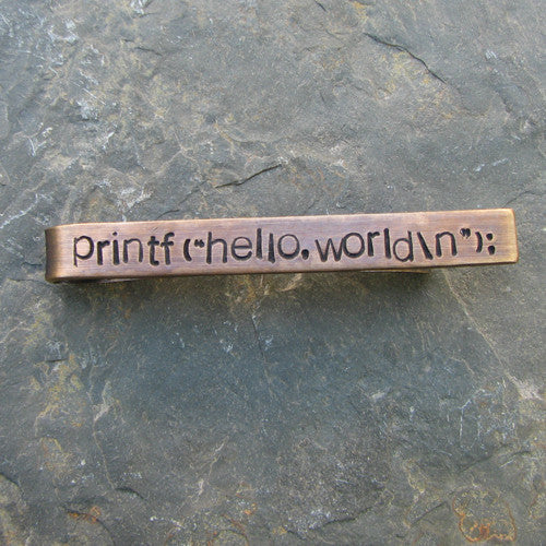 Printf(&quot;hello,world\n&quot;); tie bar - perfect science jewelry gift for computer scientists, programmers, and technology teachers and students. Tie bar is made from sturdy hand stamped bronze.