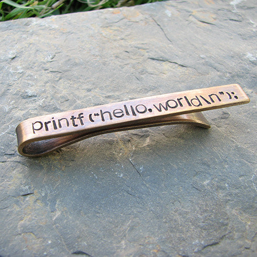 Printf(&quot;hello,world\n&quot;); tie bar - perfect science jewelry gift for computer scientists, programmers, and technology teachers and students. Tie bar is made from sturdy hand stamped bronze.