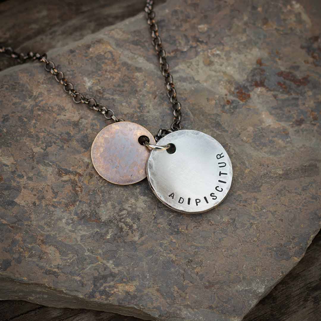 Qui Audet Adipiscitur - &quot;She Who Dares, Wins&quot; Necklace - Perfect science jewelry for innovators, experimenters, entrepreneurs,  and anyone with a dream. Makes a beautiful gift for graduations, birthdays, or starting a new challenging venture. Hand-stamped weathered bronze and aluminum discs, hung from a 28 inch gunmetal chain.